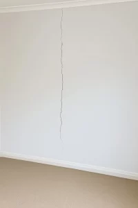 Vertical crack on southern wall in Bedroom 2 indicating potential structural issue