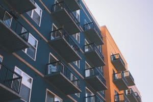 Apartment balconies attached to a blue and orange building