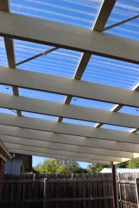Pergola roof with polycarbonate sheets showing structural beams and fixings in Berwick home inspection