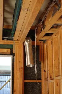 Timber framing and ductwork in subfloor showing structural and service installation conditions