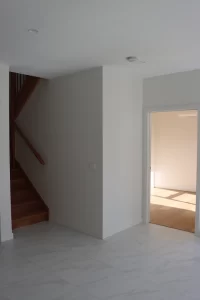 Newly built home interior showing walls, flooring and staircase ready for PCI Melbourne